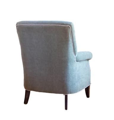 An upholstered armchair featuring a high back, classic rolled arms, and a single loose seat cushion, all covered in a textured sage green fabric. The armchair is accented with white contrast piping along its edges and stands on four dark, gently tapered wooden legs. — 3D model