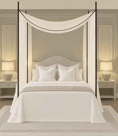 An overhead isometric view of a contemporary canopy bed featuring a minimalist black metal frame that supports a sheer white fabric canopy and drapes. The bed includes a mattress, white bedding, a light beige bed runner, and several white throw pillows. The headboard appears to be upholstered in a light, neutral fabric with a gentle curve. — 3D model