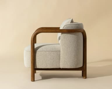 A single armchair with a wooden frame and upholstered seat, back, and armrests. It features a square-shaped seat cushion and a separate lumbar pillow. The wooden frame is visible as curved arms and legs, forming a distinct silhouette. — 3D model