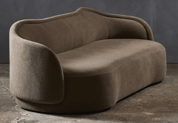 A curvaceous, two-seater sofa with a low profile and rounded armrests. The backrest features subtle vertical channel tufting, and the overall form is organic and flowing. It is upholstered in a textured fabric. — 3D model