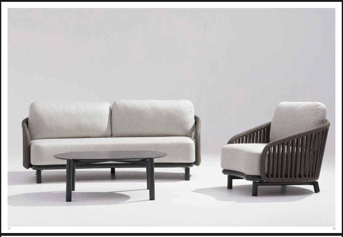 A contemporary two-seater sofa designed for outdoor use, featuring a robust black metal frame with slender, tapered legs. The backrest and armrests are crafted from dark grey woven synthetic rope, creating an open, slatted pattern that adds visual texture. The sofa includes two thick, off-white upholstered seat cushions and two matching back cushions, providing comfortable seating. Its design emphasizes clean lines and modern aesthetics, suitable for various exterior settings. — 3D model