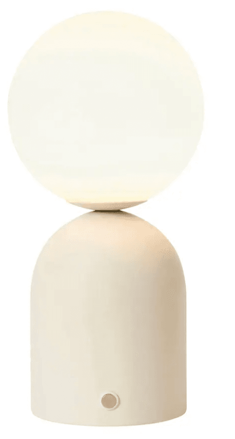 An off-white minimalist table lamp featuring a spherical frosted glass diffuser balanced atop a rounded cylindrical base. The base includes a subtle, round push-button switch near the bottom. — 3D model