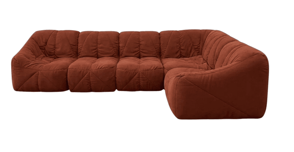 This is an L-shaped modular sectional sofa characterized by its soft, quilted upholstery in a terracotta brown color. The design features a distinctive pleated or gathered fabric appearance that creates a plush, informal, and ergonomic seating experience. The sofa consists of multiple components arranged into an L-shape, suggesting flexibility in configuration. It has a low-profile silhouette with no visible legs or rigid frame, enhancing its relaxed and inviting aesthetic. — 3D model