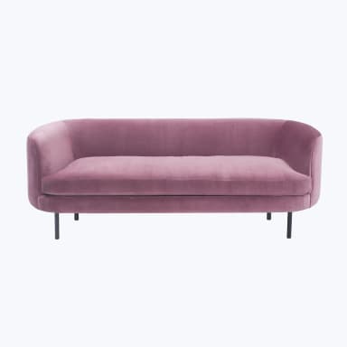 A pink velvet sofa with a curved back and arms, featuring a single seat cushion and a slender black base with four legs. — 3D model
