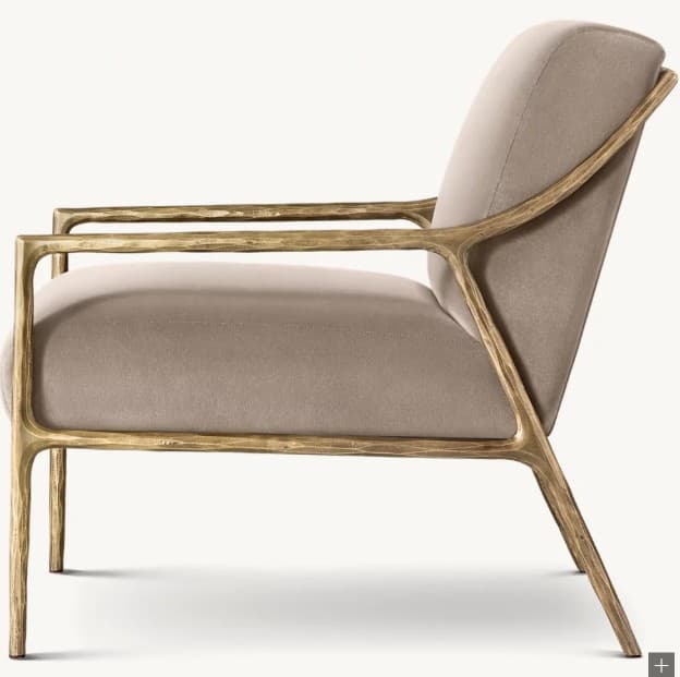 A modern armchair with a distinctive sculptural frame. The chair features a padded seat and backrest upholstered in a neutral fabric, supported by an open, organic-shaped frame that extends to form the legs and armrests. The frame has a textured, metallic finish. — 3D model
