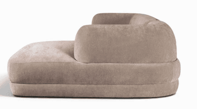 A two-piece modular sectional sofa featuring a rounded backrest and armrests, upholstered in a soft, light beige fabric. The configuration includes a main sofa unit and an attached chaise lounge. — 3D model