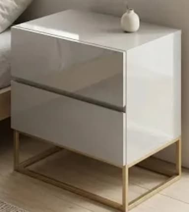 A contemporary nightstand featuring a compact, rectangular body with two integrated drawers, finished in a high-gloss light gray or off-white lacquer. The cabinet unit is supported by a minimalist, rectangular open base constructed from gold-finished metal tubing, providing a stark contrast to the glossy casework. — 3D model