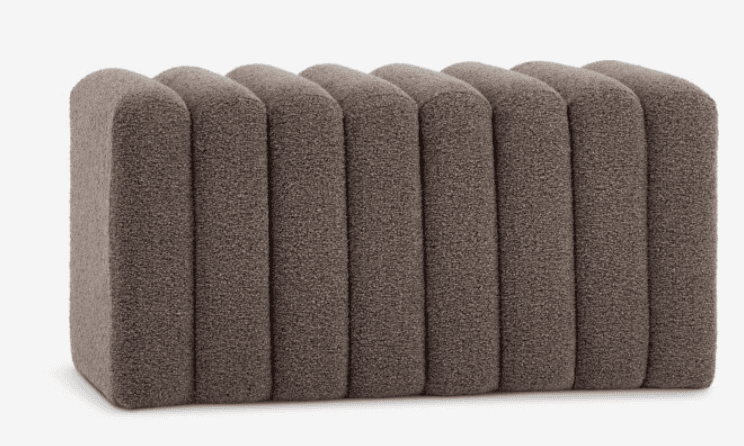 A contemporary rectangular bench featuring a distinctive fluted or channeled upholstery design. The piece is covered in a textured, brownish-gray fabric and has soft, rounded edges throughout its construction. — 3D model