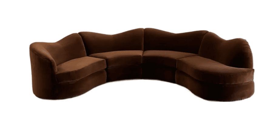 A large, modular, curved sofa with a velvet upholstery. The sofa features a sinuous, organic shape with multiple seating sections that fit together to form a cohesive unit. The backrests are low and follow the curved contour of the seating area. The base of the sofa is upholstered and appears to have a rounded, substantial form. — 3D model