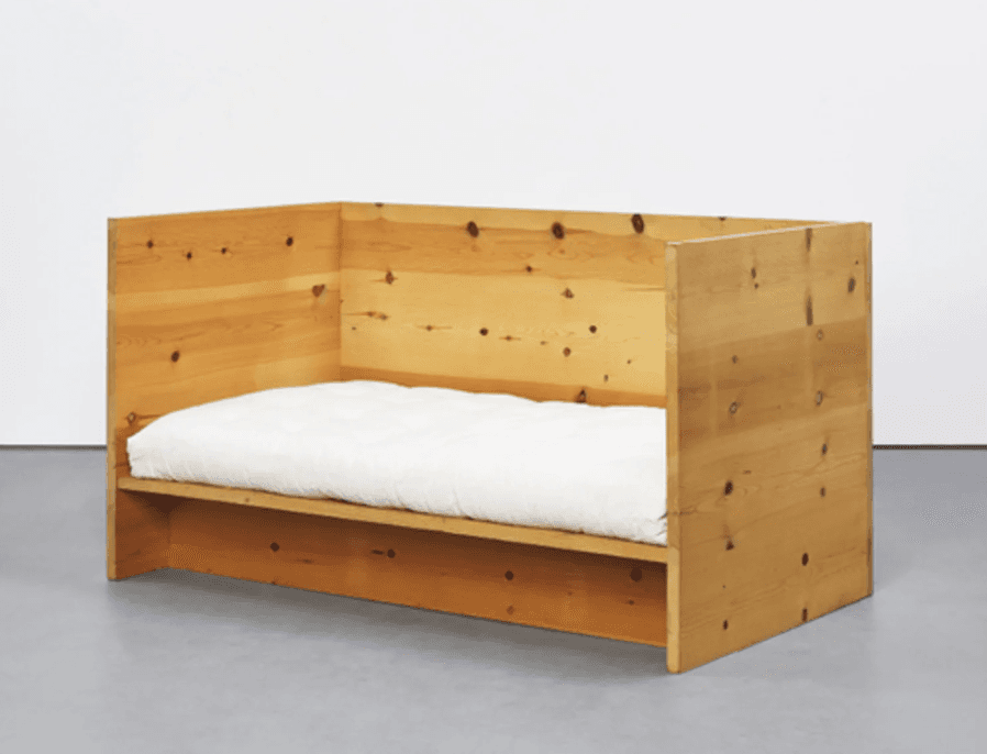 A minimalist daybed constructed from light-colored pine wood, featuring a low platform base and integrated tall side and back panels. It is fitted with a simple, off-white mattress. — 3D model