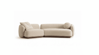 A two-piece modular sectional sofa upholstered in cream boucle fabric, featuring soft, rounded forms and resting on a dark wooden plinth base. One section includes a loose back cushion, and the other has a cylindrical bolster cushion. — 3D model