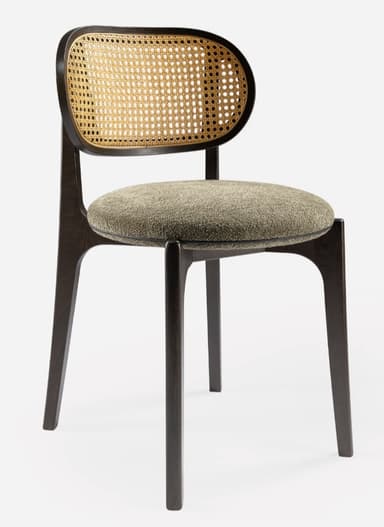A modern side chair featuring a dark wooden frame with a distinctive curved backrest. The backrest incorporates a woven cane panel. The seat is upholstered in a textured, neutral-toned fabric. The legs are tapered and angled outwards, contributing to a sleek silhouette. — 3D model