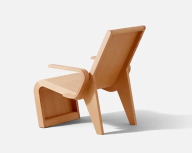 A modernist bent plywood lounge chair with a natural, light wood finish, featuring a reclined backrest and integrated armrests. The chair showcases a continuous, organic form crafted from laminated wood sheets. — 3D model