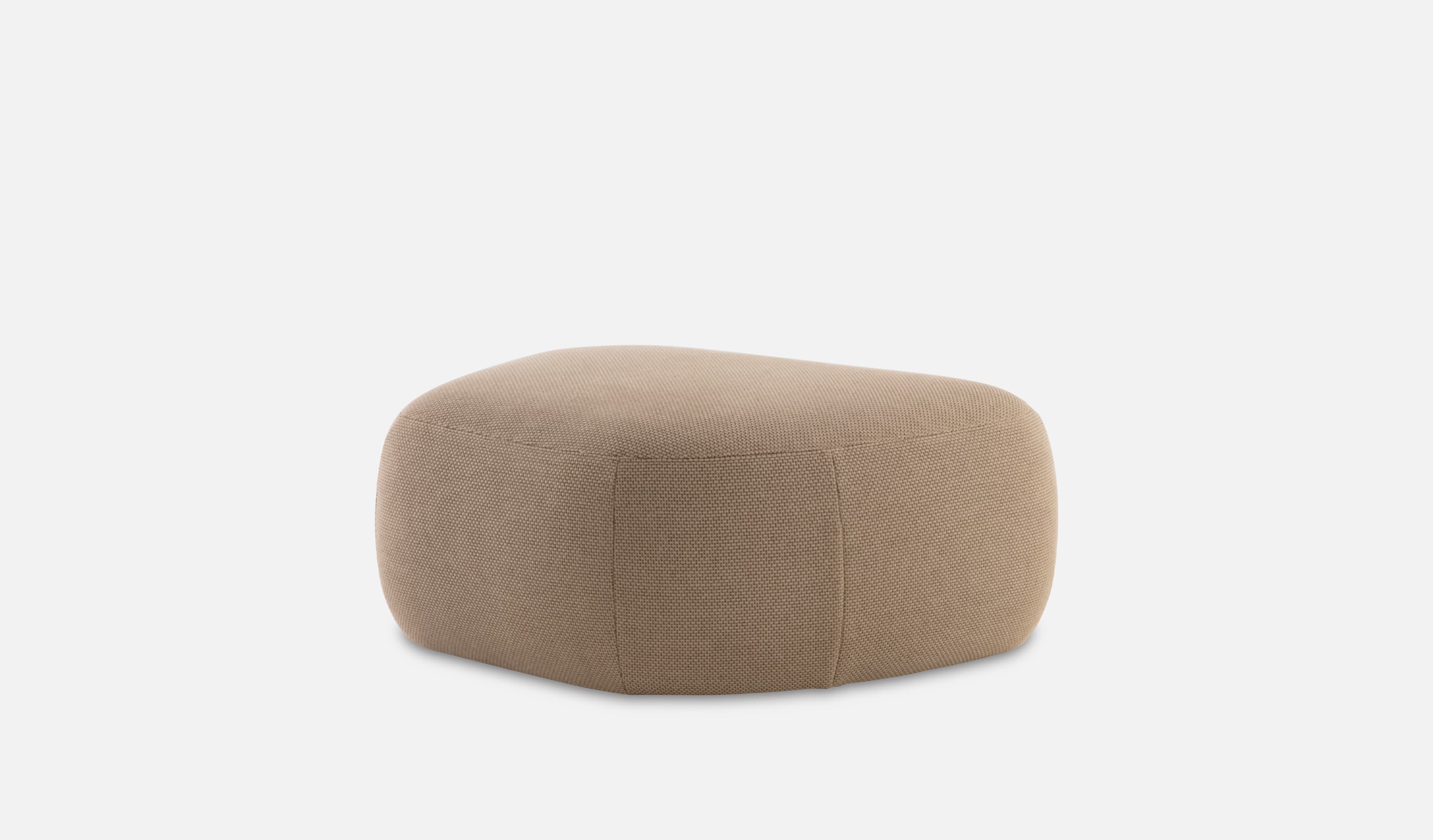 A cushioned ottoman with a rounded, somewhat irregular, rectangular shape. The ottoman appears to be upholstered in a beige, textured fabric with a subtle weave.  The seams are visible, particularly a central seam running along the length of the ottoman. The overall form is soft and rounded, without sharp edges or corners. — 3D model