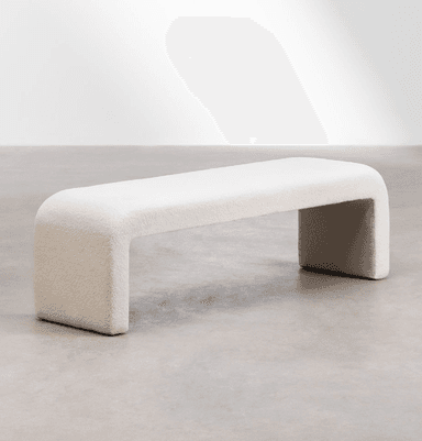 A cream-colored, bouclé upholstered bench with a rounded, continuous form. The bench has a singular, sculptural design where the seat and legs are integrated into a unified U-shape, creating a modern and minimalist aesthetic. — 3D model