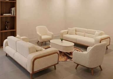 An oval-shaped modern coffee table featuring a white fluted body and natural wood splayed legs. — 3D model