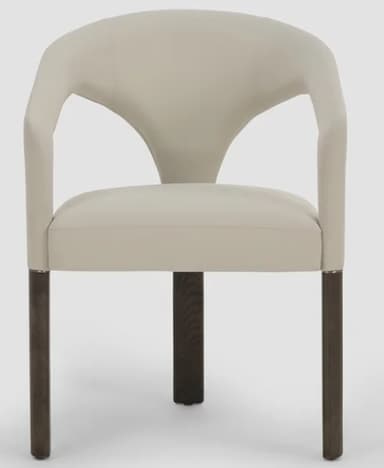 A contemporary armchair featuring a distinctive curved, upholstered backrest that flows seamlessly into integrated armrests. The seat is also upholstered, and the chair is supported by four dark, tapered wooden legs. The overall aesthetic is modern and sleek, with a neutral color palette. — 3D model