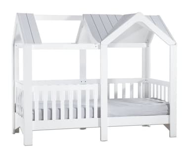 A white wooden bed frame designed to resemble a house, featuring a gabled roof structure and slatted side rails. The frame is constructed from solid wood with a clean white painted finish. A mattress is visible within the frame, indicating it is a complete bed setup. The design is whimsical and child-oriented. — 3D model