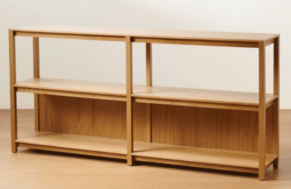 A long, low wooden shelving unit with two tiers of shelves. It appears to be constructed from solid wood or wood veneer and features an open design on the front and top, with vertical supports and horizontal shelves. The back panels are solid wood, creating a divided storage space. The unit is divided into two sections by a central vertical support. — 3D model