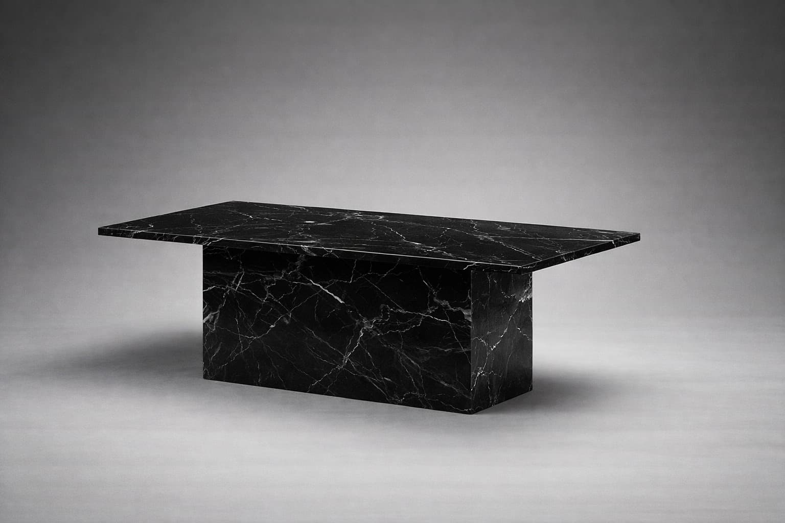 A rectangular coffee table with a monolithic design. The table features a thick, flat top supported by a solid, block-like pedestal base. The entire piece is constructed from black marble with prominent white veining, creating a striking contrast. The form is geometric and minimalist, emphasizing the material's natural pattern. — 3D model