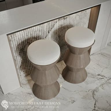 A modern stool featuring a light-colored wooden base with a distinctive faceted, hourglass-like form, topped with a round, white upholstered cushion. — 3D model