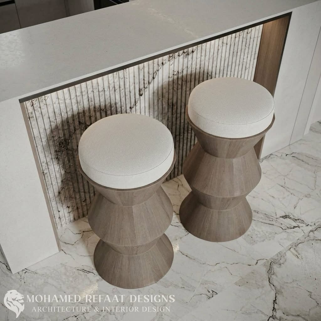 A modern stool featuring a light-colored wooden base with a distinctive faceted, hourglass-like form, topped with a round, white upholstered cushion. — 3D model