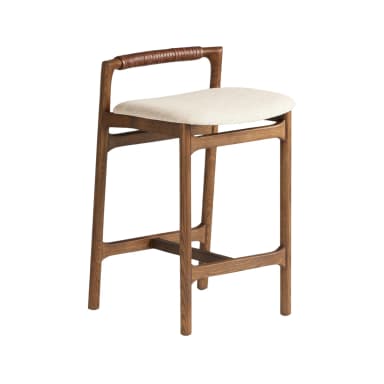 A contemporary bar stool featuring a solid wood frame with a dark brown finish. It has four slightly splayed legs connected by an integrated footrest. The seat is round and generously cushioned, upholstered in a light cream or off-white textured fabric. A low backrest, formed by a curved wooden rail, is distinctly wrapped in tan leather cording, providing both a visual detail and a handle-like support. — 3D model