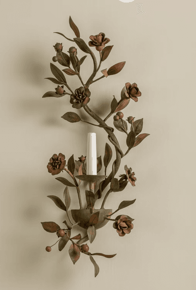 A wall-mounted light fixture designed as an intricate botanical arrangement of metallic leaves, flowers, and berries, featuring a single candle-style light source. — 3D model
