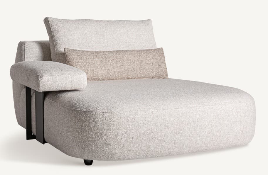 A modern chaise lounge with a curved, rounded silhouette. It features a textured, light-colored fabric upholstery. The piece includes a high backrest, an integrated armrest with a metal support structure, and a long, supportive bolster cushion. The overall design suggests a focus on comfort and contemporary aesthetics. — 3D model