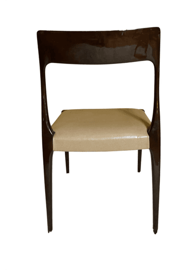 A minimalist chair featuring a dark, possibly rosewood or mahogany, curved frame and slender, tapered legs. The seat and a small upper backrest pad are upholstered in a light, cream-colored material, likely leather or faux leather. The chair has an elegant, streamlined profile, characteristic of mid-century design, designed for dining or as an accent piece. — 3D model