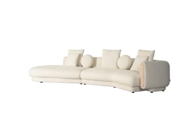 A large, curved sectional sofa upholstered in a light, textured boucle fabric, featuring a left-hand chaise extension and a unique right-hand armrest with a recessed wooden panel. The sofa includes several matching decorative pillows, both square and round. — 3D model