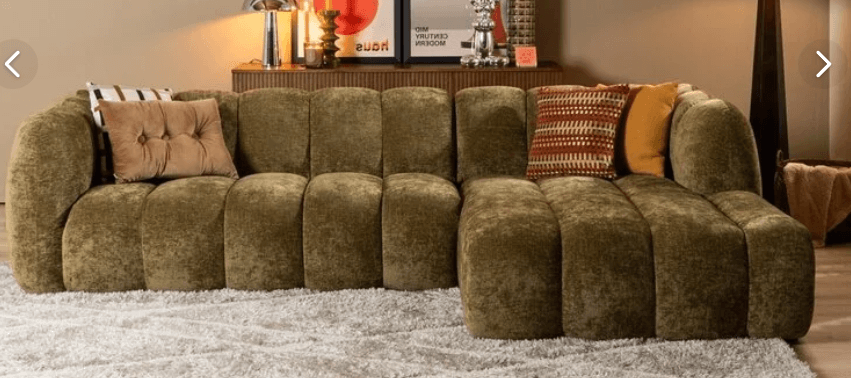 A large, multi-piece modular sectional sofa with olive green channel-tufted upholstery, configured in a broad L-shape with an additional chaise-like extension. It includes two decorative throw pillows. — 3D model