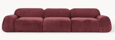 A modular sofa with a plush, textured upholstery. The sofa consists of multiple distinct sections that can be arranged in various configurations. Each section has a rounded, continuous form, suggesting a soft and inviting design. The armrests and backrests are integrated into the overall structure with soft, curved edges, and the seat cushions are plump and well-defined. — 3D model