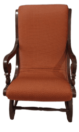 A traditional upholstered armchair featuring a dark-stained carved wood frame and rust-colored patterned fabric. The chair has curved armrests with scroll details at the front, turned elements on the front leg supports, and an upholstered seat and backrest. The backrest is gently curved, contributing to a classic and formal aesthetic. — 3D model