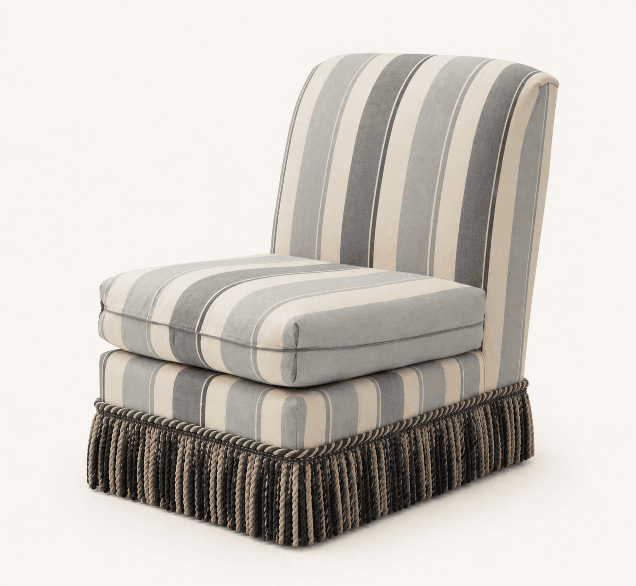 An armless slipper chair, fully upholstered in a vertically striped fabric featuring various shades of grey and cream. It features a loose, box-style seat cushion and a decorative tasseled fringe skirt at the base, concealing its legs. — 3D model