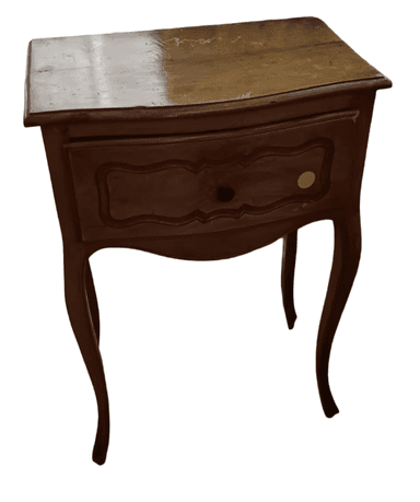 A wooden nightstand with a single drawer and curved legs. The drawer front features an ornate, molded design. The top surface appears to be lighter wood and shows some signs of wear. The body and legs are a darker, polished wood. — 3D model