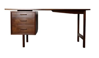 A vintage Mid-Century Modern wooden executive desk featuring a dark brown finish. The desk comprises a broad rectangular tabletop supported by two slim, square-profile legs on one side, connected by a stretcher bar. The opposite side features a cantilevered or 'floating' rectangular drawer pedestal, supported by two shorter, slightly splayed legs. The design emphasizes clean lines and a minimalist aesthetic typical of the era. — 3D model