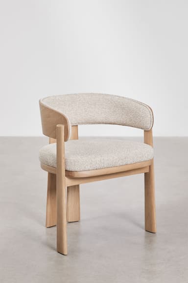 A modern dining chair featuring a solid light oak wood frame and light-colored textured fabric upholstery. The chair has a gently curved backrest that seamlessly transitions into integrated armrests, forming a barrel-like shape. The legs are robust and subtly tapered, contributing to its minimalist and contemporary aesthetic. The seat and inner backrest are cushioned. — 3D model