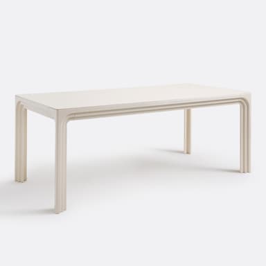 A close-up view of a table's surface and leg. The surface appears to be a high-gloss, off-white material, reflecting light. The leg has a distinctive carved design with layered, curved elements, reminiscent of a waterfall or architectural molding. The overall construction suggests a modern or contemporary style. — 3D model