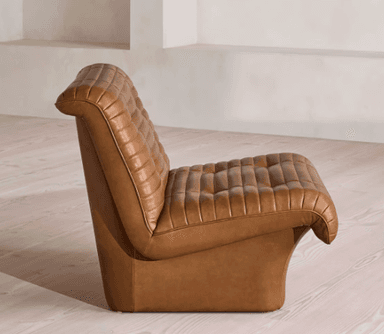A single-seater armchair upholstered in brown leather with a tufted and channel-stitched design. The chair features a low-profile, boxy base and integrated armrests that flow into the seat and backrest. The upholstery exhibits consistent stitching and button tufting on the backrest and seat cushion. — 3D model