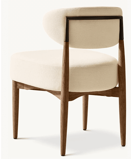 An armless chair featuring a curved, upholstered seat and backrest in a light-colored fabric, supported by a dark stained wooden frame with a contrasting dark metal element at the back. — 3D model