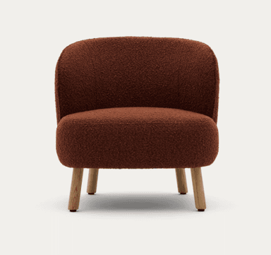 A low-profile, armless lounge chair upholstered in a textured, reddish-brown (burnt orange) boucle fabric. The chair features a compact, rounded silhouette with a gently curved backrest that flows into the deep seat. It is supported by four short, subtly splayed wooden legs. — 3D model