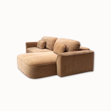 A sectional sofa with a chaise lounge extension. The sofa features a low profile, deep seating, and plush cushions. It is upholstered in a textured fabric and includes two rectangular throw pillows. — 3D model