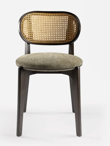 A modern side chair featuring a dark wooden frame with a distinctive curved backrest. The backrest incorporates a woven cane panel. The seat is upholstered in a textured, neutral-toned fabric. The legs are tapered and angled outwards, contributing to a sleek silhouette. — 3D model