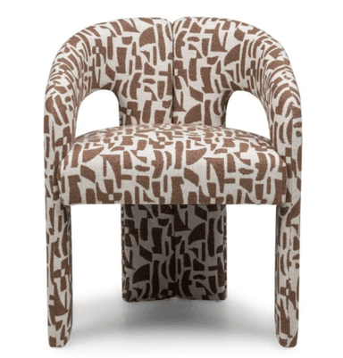 A fully upholstered armchair featuring a continuous, curved barrel-shaped backrest and integrated armrests. The chair is covered in a fabric with a distinctive brown and white abstract geometric pattern. Its base and legs are also upholstered, giving it a monolithic and sculptural appearance. — 3D model