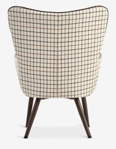 An armchair with a high, curved back and integrated armrests, upholstered in a fabric with a plaid pattern. The chair features four tapered wooden legs with protective caps at the base. — 3D model