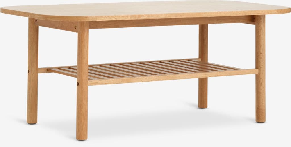 A light-toned wooden coffee table featuring an oval-shaped top and a slatted lower shelf. The table has four cylindrical legs. The wood appears to be oak, with a natural finish, and all edges are softly rounded for a refined aesthetic. The slatted shelf provides additional storage or display space. — 3D model