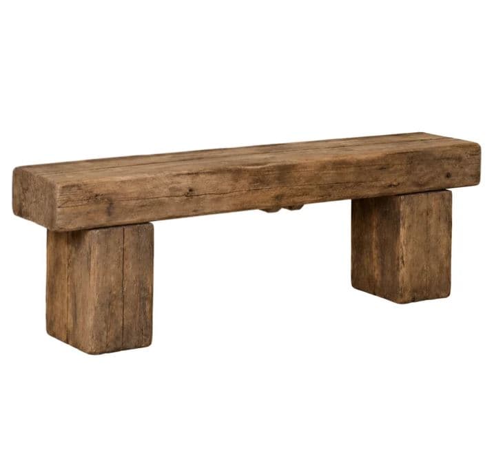 A rustic bench crafted from thick, heavy reclaimed wood planks, featuring a simple, robust design with a single horizontal seat supported by two sturdy, block-like legs. — 3D model