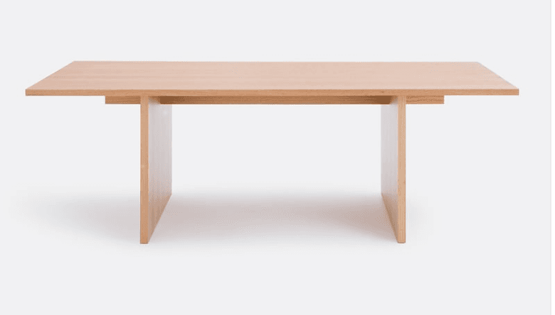 A light-toned wooden rectangular table featuring a thick tabletop and two robust slab-style legs, creating a clean, minimalist aesthetic. The construction is solid and appears to be made of natural wood or a high-quality wood veneer. — 3D model