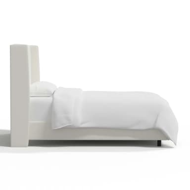 A white upholstered bed frame with a tall, winged headboard. The bed is dressed in white linens, including a duvet and pillows. Dimensions are provided: 55 inches in height for the headboard, 85 inches in length, and 65 inches in width. The frame itself appears to be a platform style with a low profile, indicated by the 4-inch measurement. The legs are black and barely visible. — 3D model